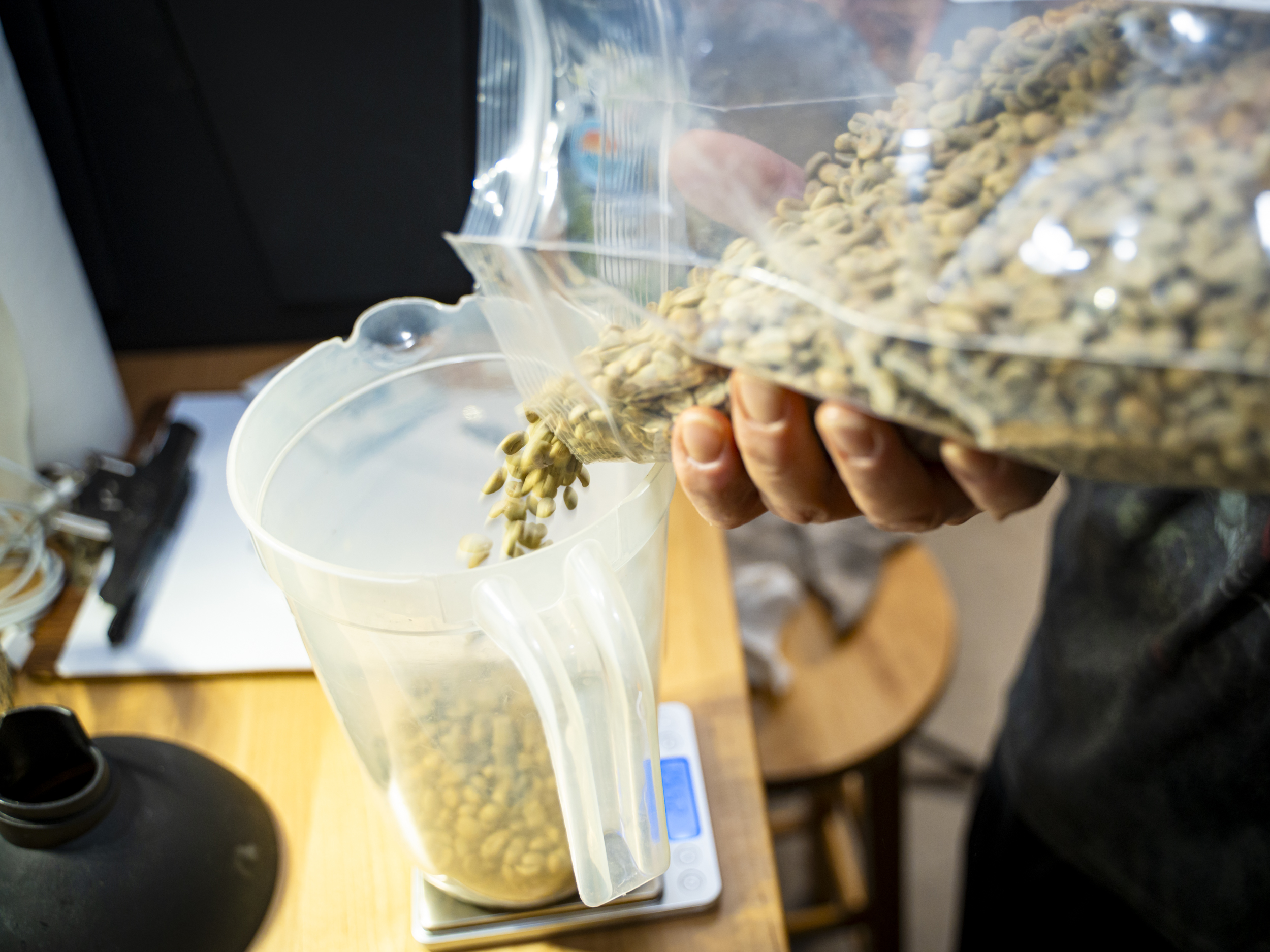 Small-Batch Specialty Coffee, Roasted in Arizona Precisely weighing green coffee beans before small-batch roasting, Fire n Grind Gilbert Arizona
